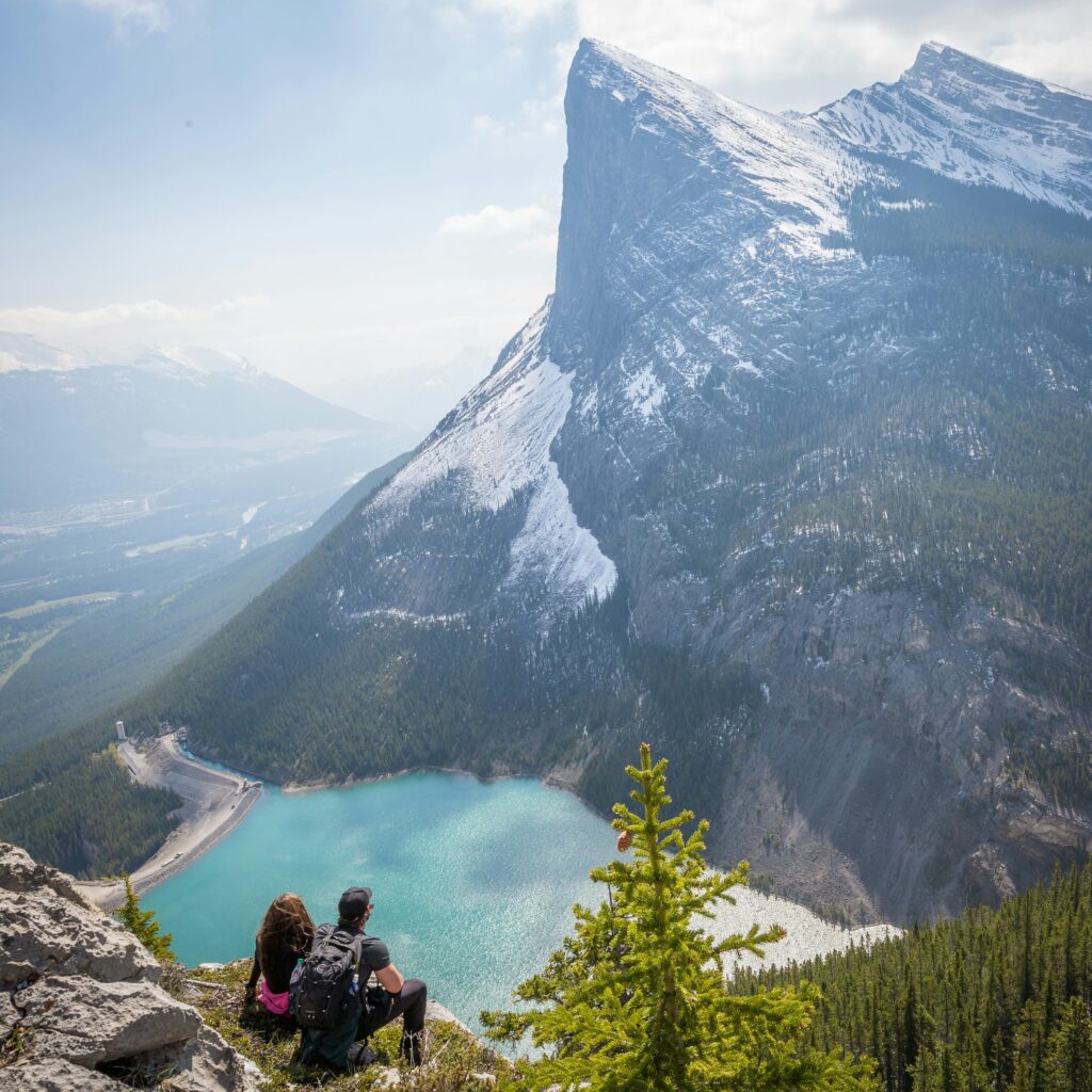 Couple sitting staring at a mountain in the distance